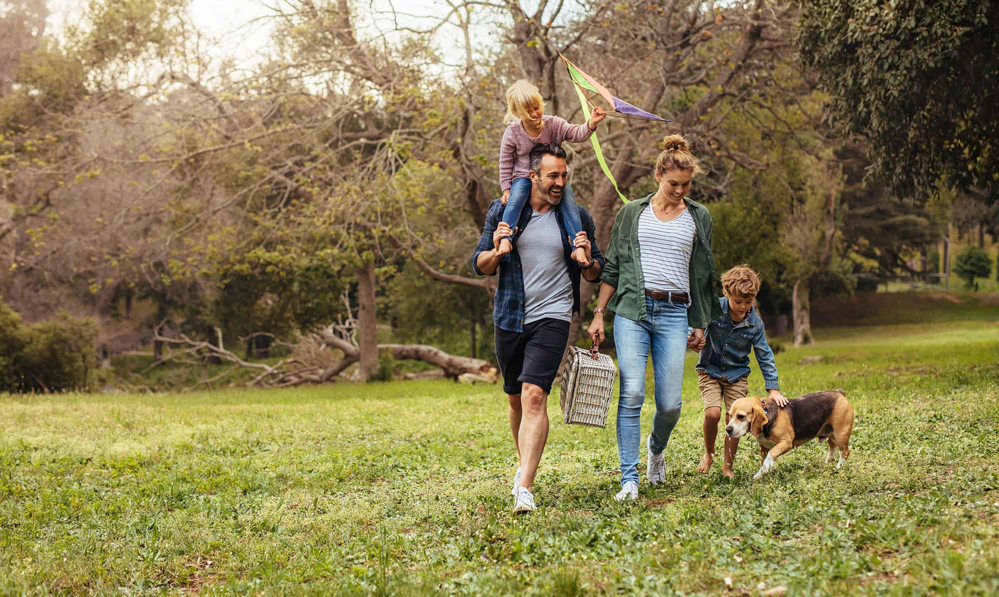 Happy couple with their two children and dog